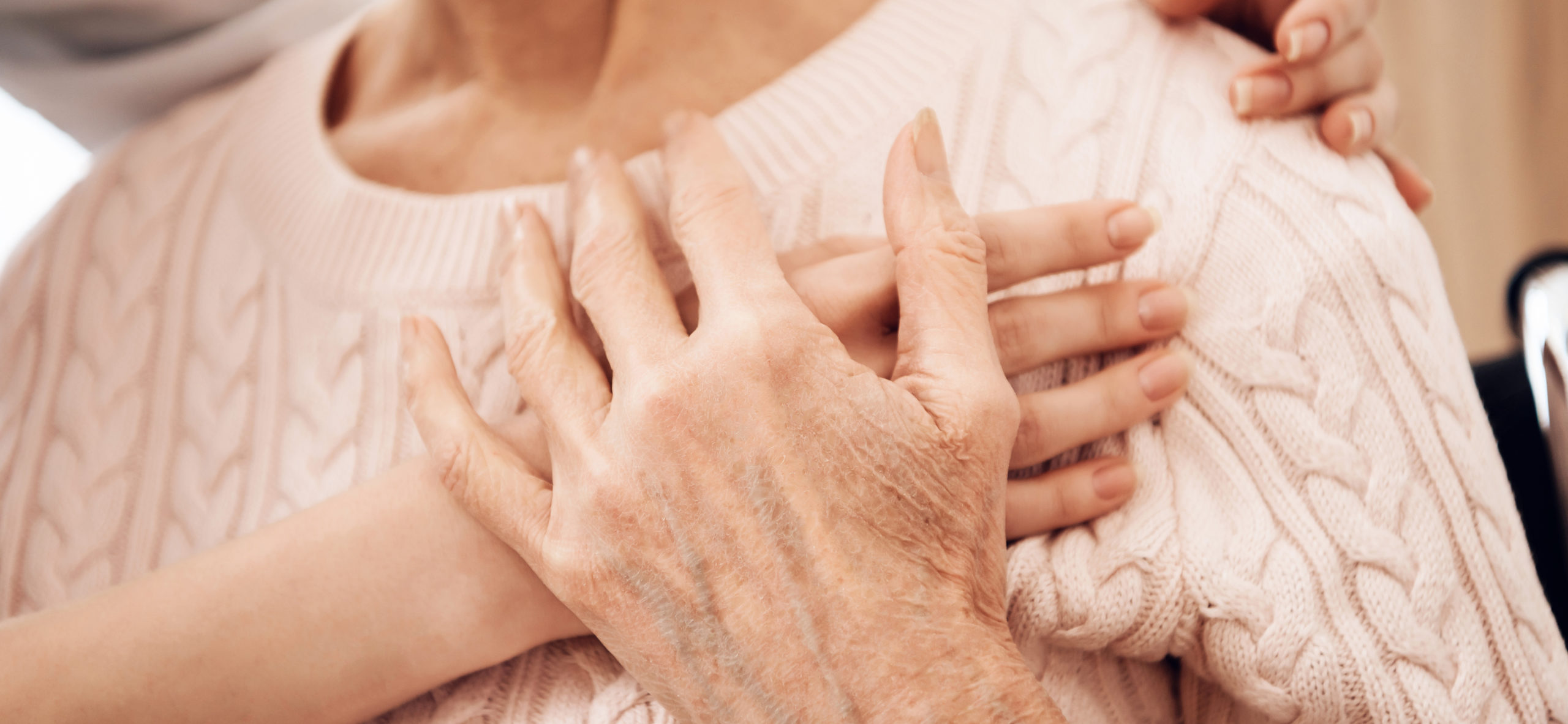 caregiver gently placing hand over loved one's heart
